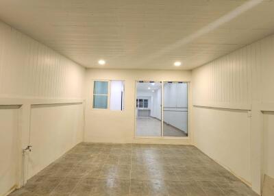 Empty room with tiled floor and wooden ceiling