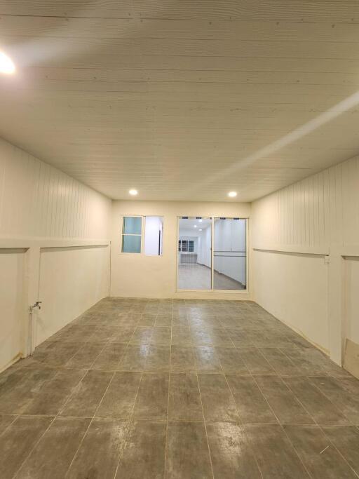 Empty room with tiled floor and wooden ceiling