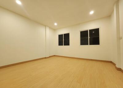 Spacious unfurnished living room with wooden flooring and recessed lighting