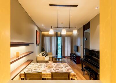 Spacious living and dining area with modern decor and ample lighting