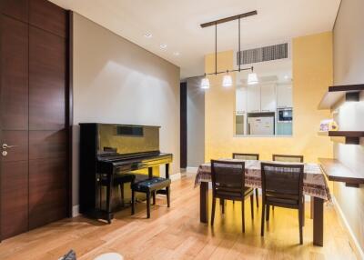 Dining room with a dining table, chairs, and a piano