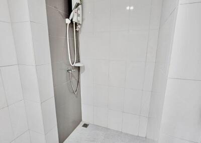 Shower area with tiles and electric shower unit