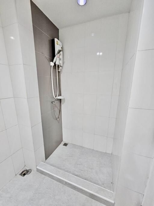 Shower area with tiles and electric shower unit