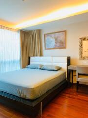 Modern bedroom with wooden floor and natural light