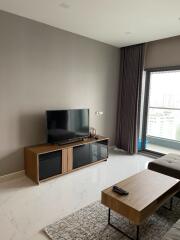 Modern living room with a TV and large window