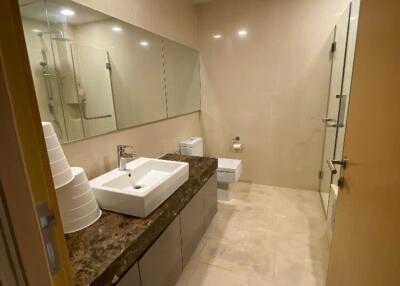 Modern bathroom with dual sinks and glass shower