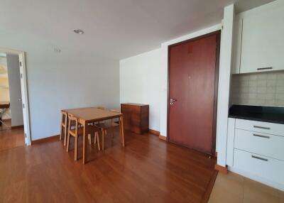 Modern apartment living area with a dining table and chairs