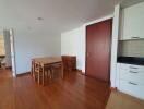 Modern apartment living area with a dining table and chairs