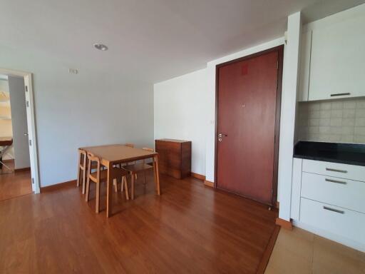 Modern apartment living area with a dining table and chairs