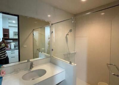 Modern bathroom with glass shower enclosure and vanity countertop