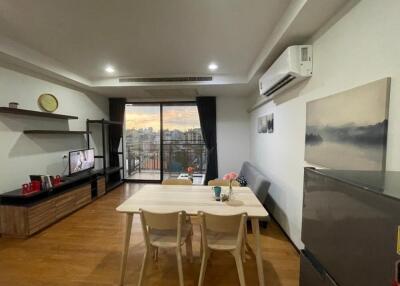 Modern living room with dining area and balcony view