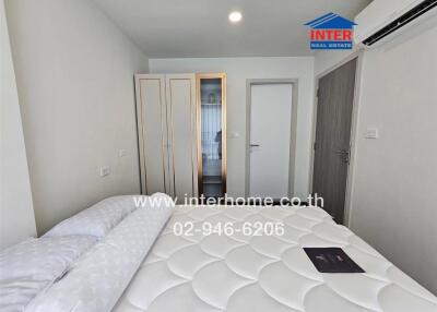 Modern bedroom with a double bed, wardrobe, and air conditioning unit