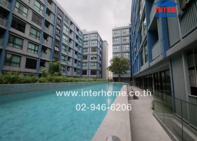 Outdoor view of apartment complex with swimming pool