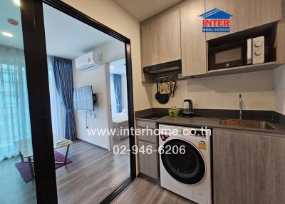 Modern kitchen area with laundry facilities