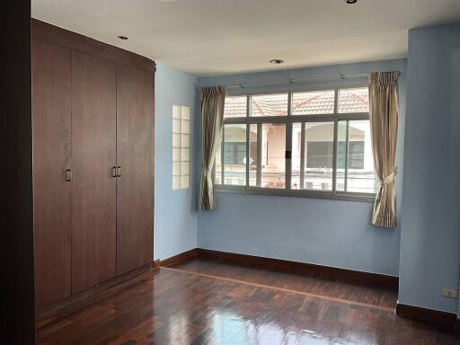 Bedroom with large window and built-in wardrobe