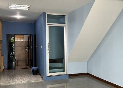 View of the main living area with tiled flooring and staircase