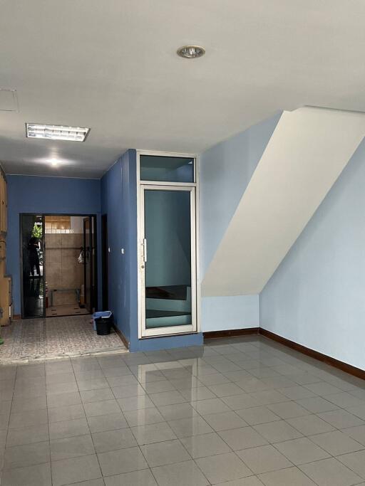 View of the main living area with tiled flooring and staircase