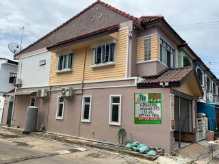 Exterior view of a two-story house with a signboard in front