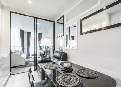 Modern living area with dining table and glass doors