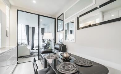 Modern living area with dining table and glass doors