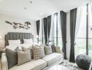 Bright and cozy modern bedroom with large windows, sofa, and stylish decor