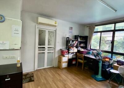 Room with wooden flooring, study desk, and large window