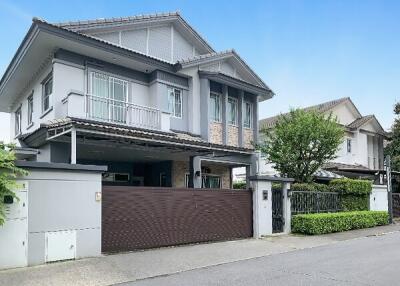 Modern two-story house exterior with driveway and front yard