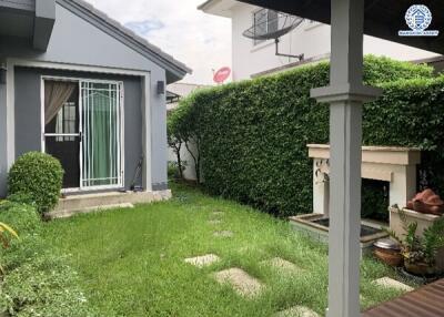 Well-maintained backyard with a small lawn and greenery