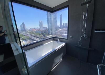 Modern bathroom with large window and city view