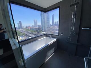 Modern bathroom with large window and city view