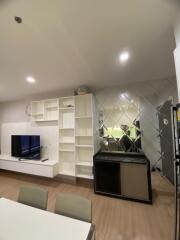 Modern living room with wall-mounted TV and open shelves