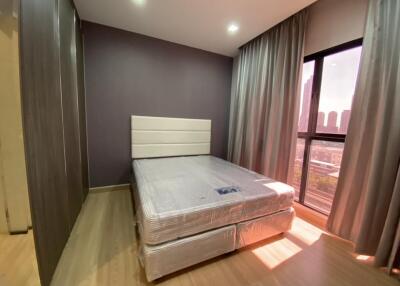 Modern bedroom with a window view and curtains