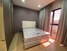 Modern bedroom with a window view and curtains