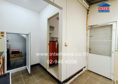 Utility room with storage and access to small outdoor space