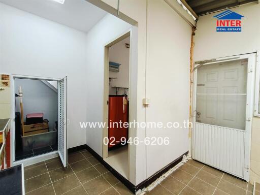 Utility room with storage and access to small outdoor space