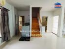 Living area with staircase and kitchen appliances