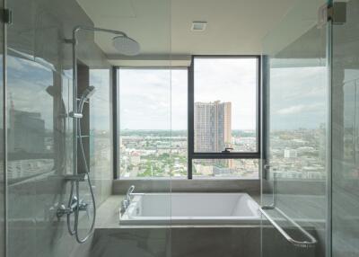 Modern bathroom with large window and city view