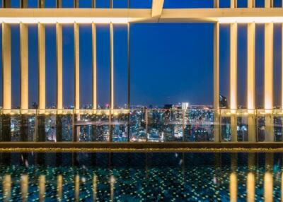 View from building with pool and cityscape at night