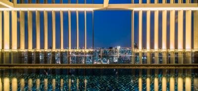 View from building with pool and cityscape at night