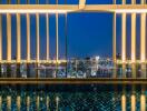 View from building with pool and cityscape at night