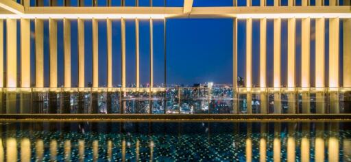 View from building with pool and cityscape at night