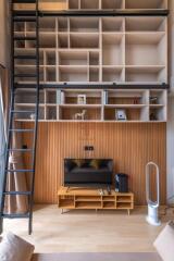 Modern living room with a loft-style bookshelf and entertainment center