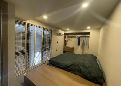 Modern bedroom with bed, wardrobe, and large window