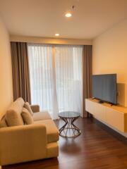 Modern living room with sofa, TV, and coffee table