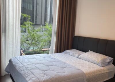 Bedroom with large window and contemporary furnishings