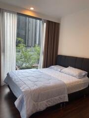 Bedroom with large window and contemporary furnishings