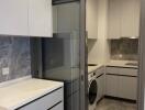 Modern kitchen with integrated washer-dryer and sleek cabinets