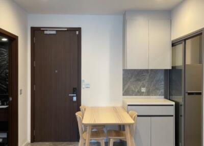 Modern kitchen and dining area with a wooden table and chairs