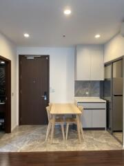 Modern kitchen and dining area with a wooden table and chairs