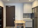 Modern kitchen and dining area with a wooden table and chairs